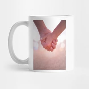 Close up of young female and male hands holding. Mug